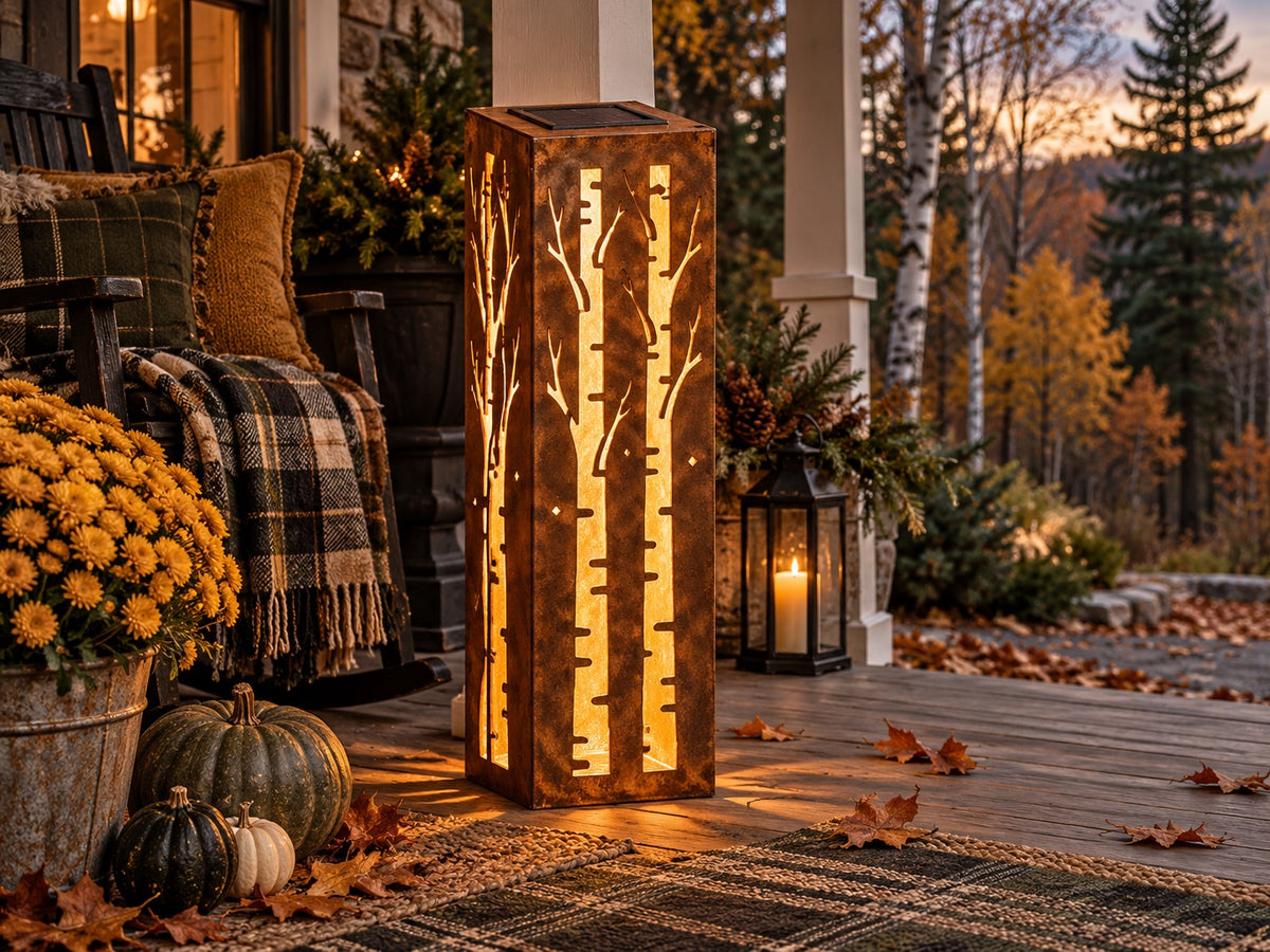 32-inch rusted birch tree solar steel luminary on an autumn woodland porch, view 1