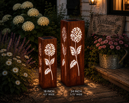 24 & 32 inch Hydrangea solar metal garden luminary set with glowing floral cutouts in a cottage garden