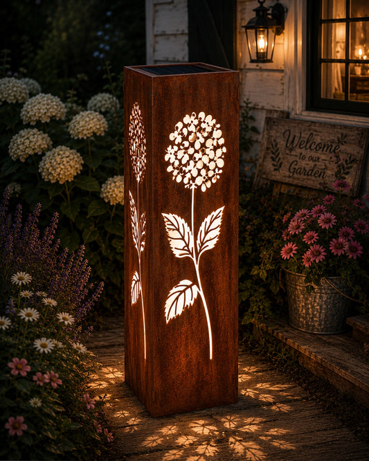 32 inch Hydrangea solar metal garden luminary with glowing floral cutouts in a cottage garden